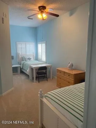 a bedroom with furniture and a chandelier