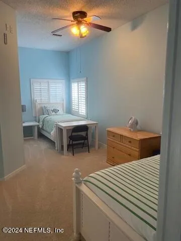 a bedroom with furniture and a chandelier