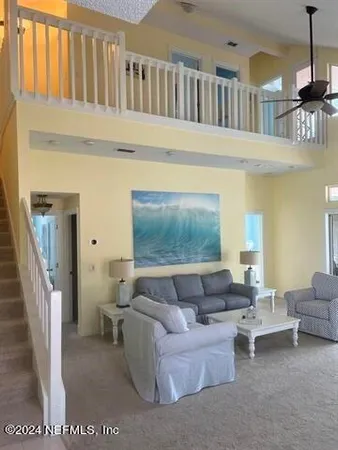 a living room with furniture and a dining table