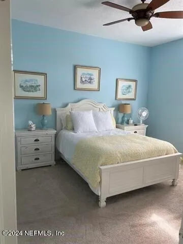 a bedroom with a bed and night stand