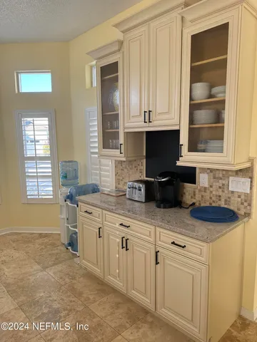 a kitchen with white cabinets and a sink