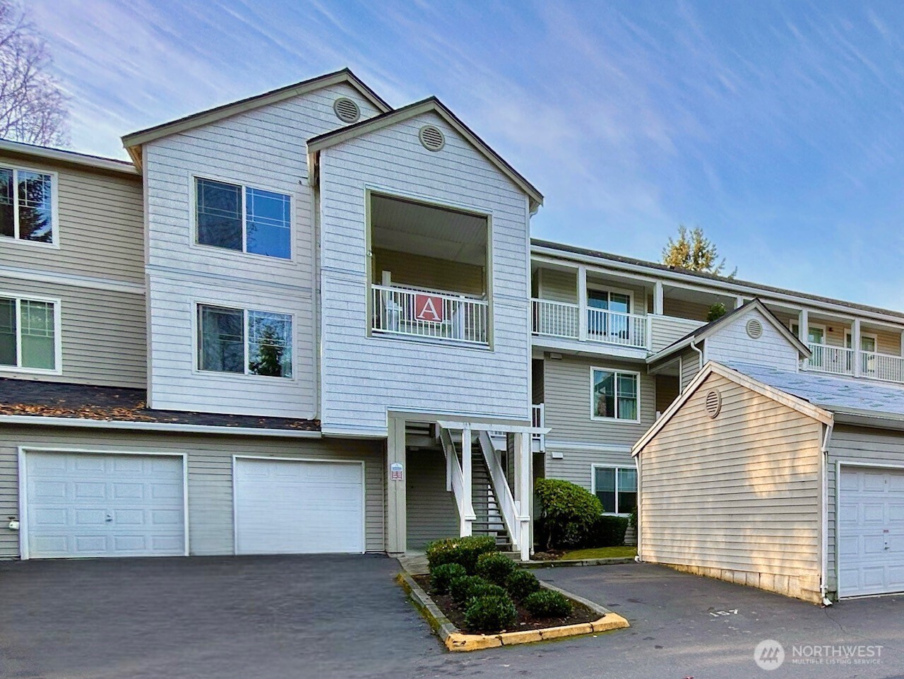 2009 196th Street Southeast, Unit A203 Bothell, WA 98012 - Photo 1 of 19 a front view of a house with garden
