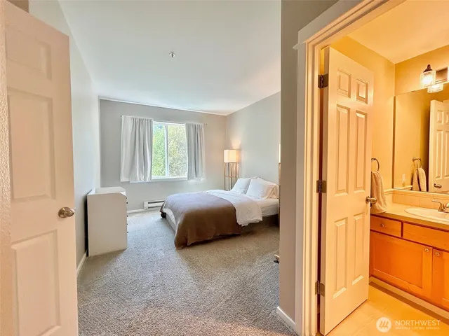 a bedroom with a bed and a chair with the outer view