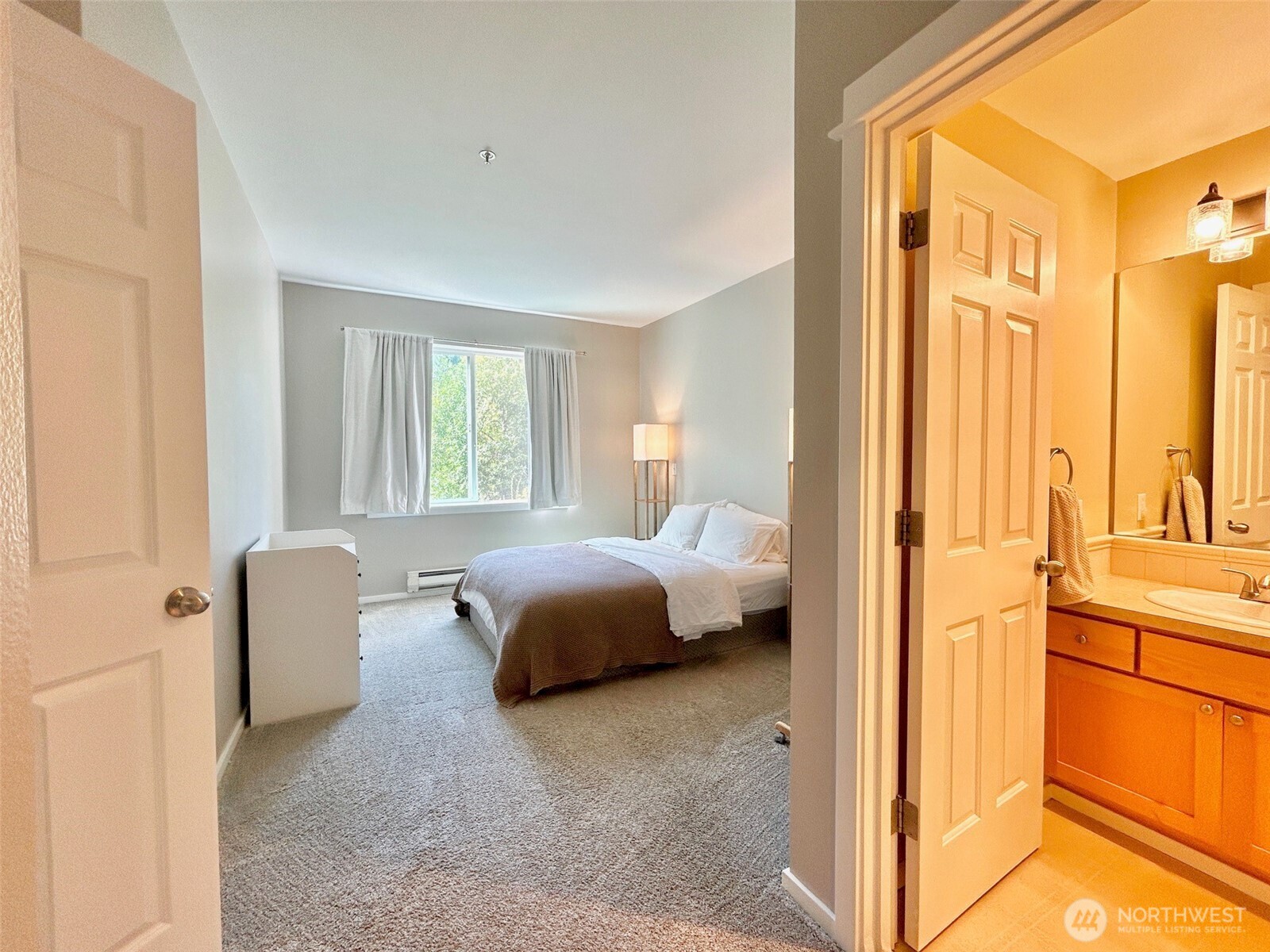 2009 196th Street Southeast, Unit A203 Bothell, WA 98012 - Photo 15 of 19 a bedroom with a bed and a chair with the outer view