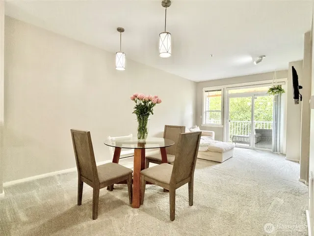 a dining room with furniture a chandelier and wooden floor