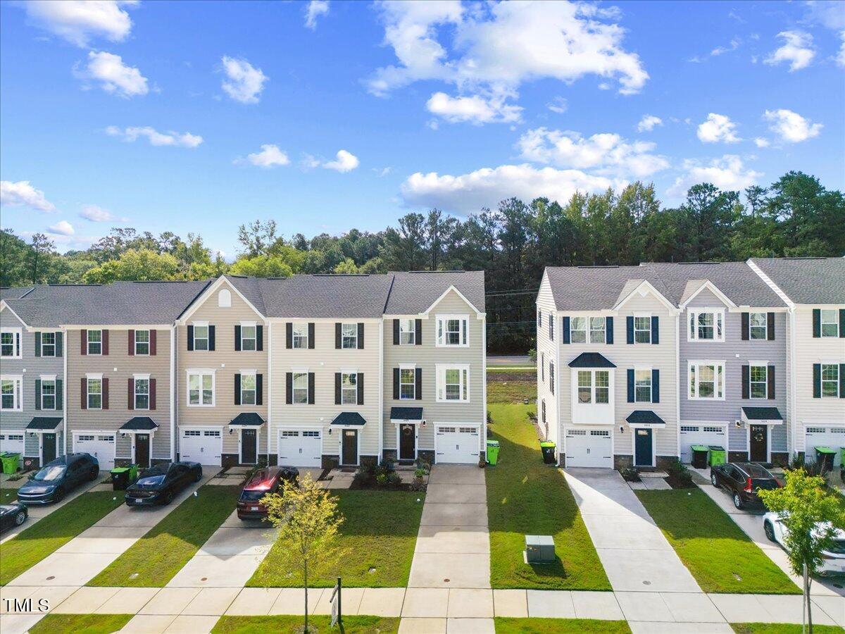 6620 Pathfinder Way Raleigh, NC 27616 - Photo 2 of 39 a view of big yard with large trees and couches chairs