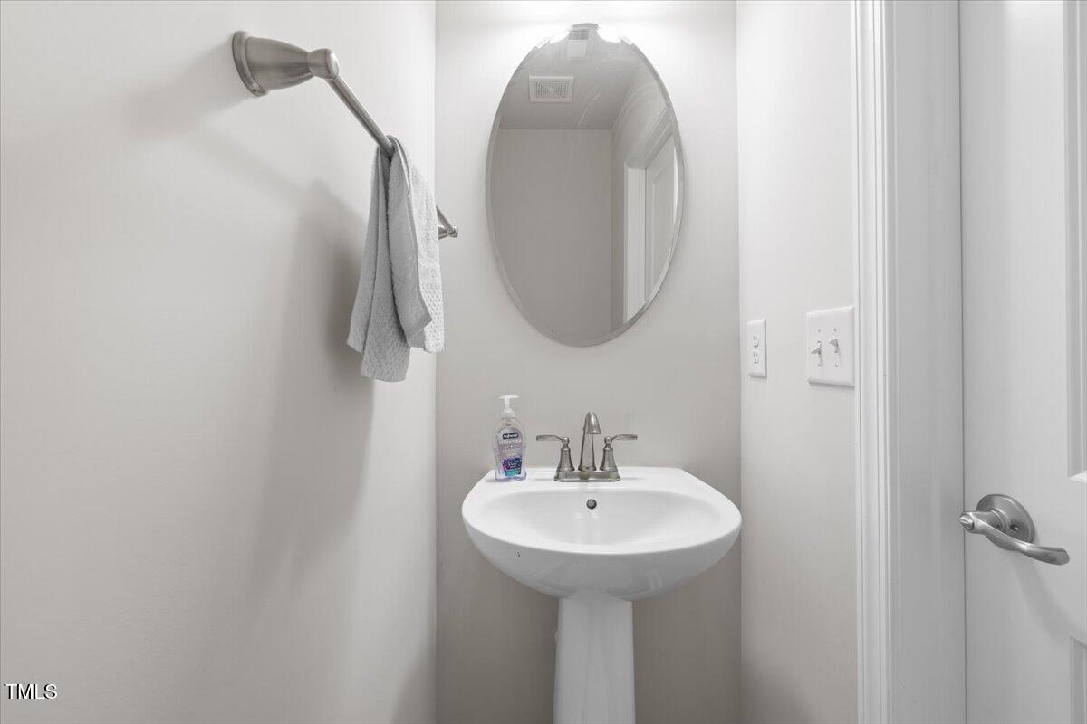 6620 Pathfinder Way Raleigh, NC 27616 - Photo 23 of 39 a bathroom with a sink and a mirror