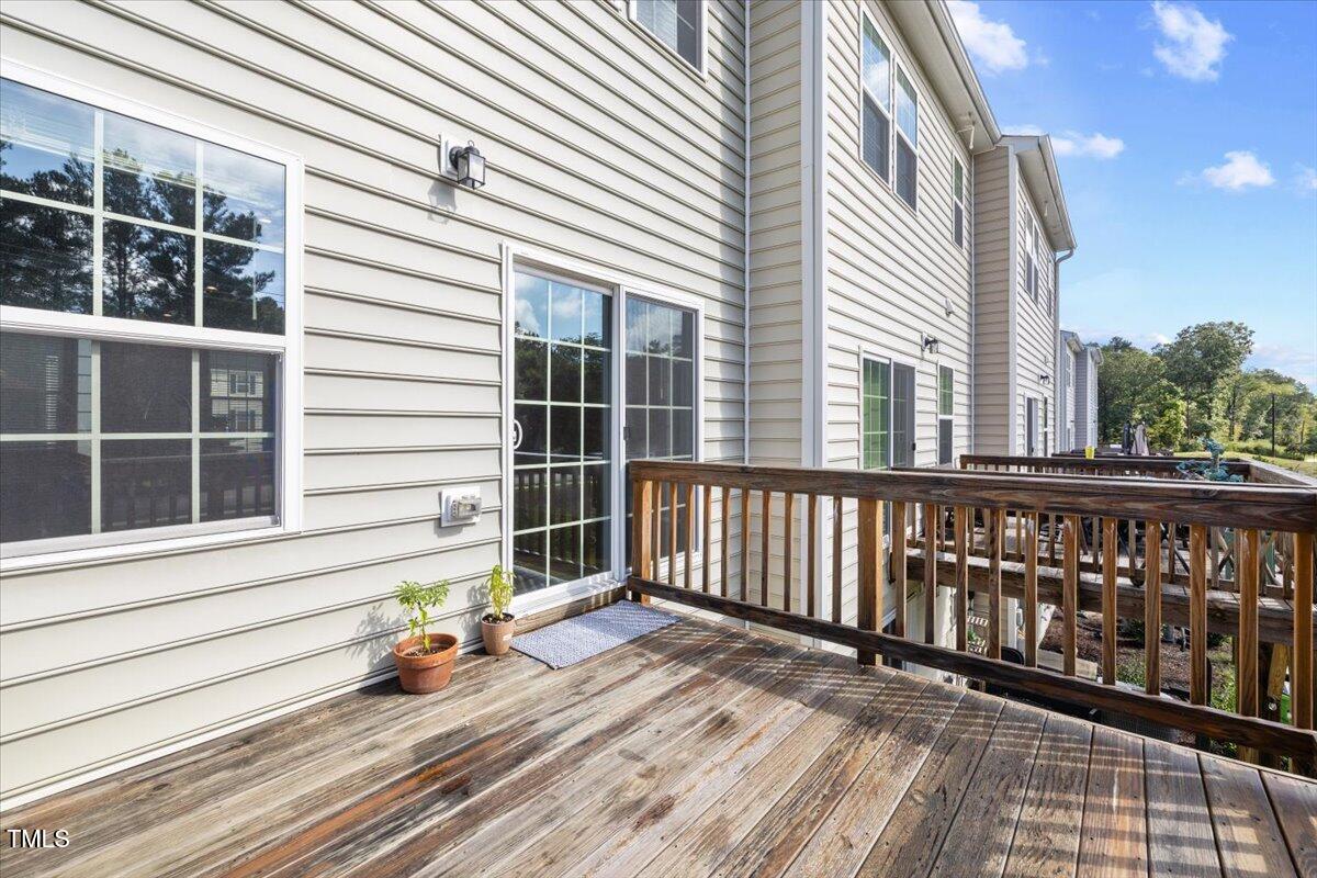 6620 Pathfinder Way Raleigh, NC 27616 - Photo 37 of 39 a view of a wooden balcony with a barbeque