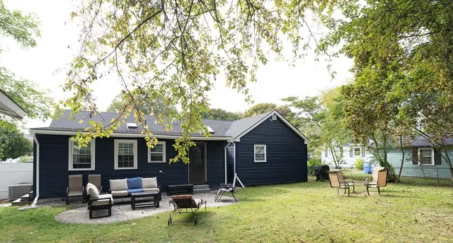 a view of a house with backyard porch and sitting area