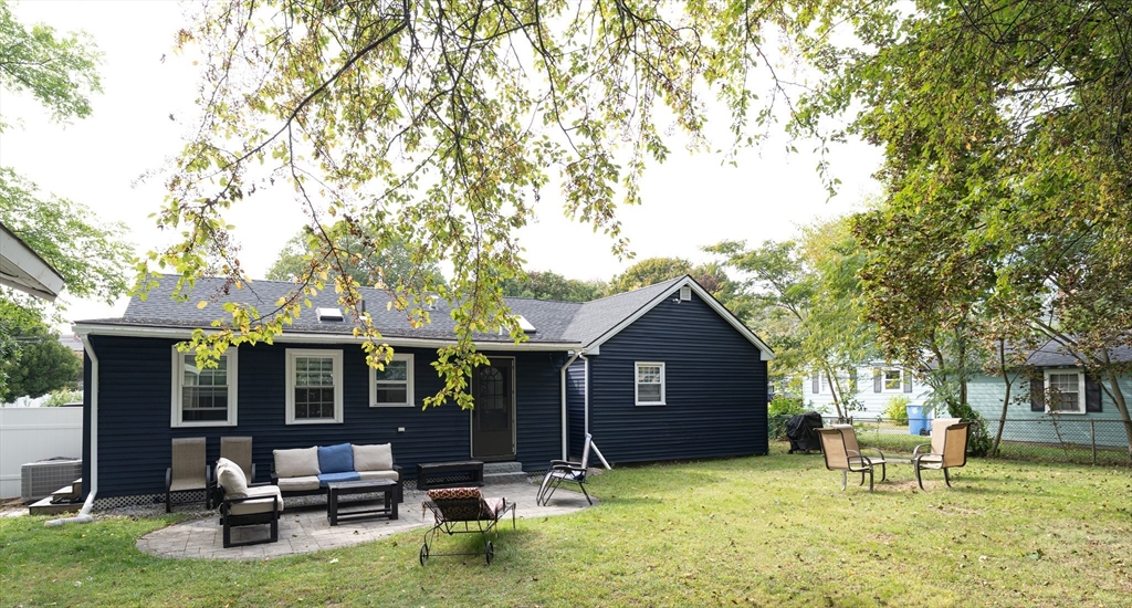 a view of a house with backyard porch and sitting area
