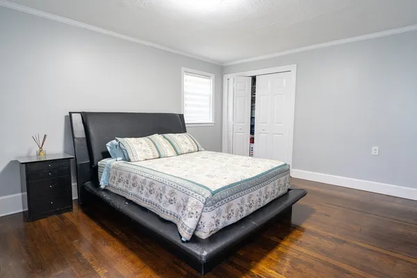 a bed sitting in a bedroom next to a window