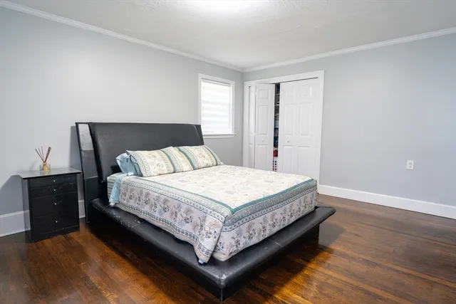 a bed sitting in a bedroom next to a window