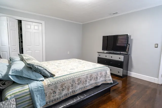 a bedroom with a bed and a television