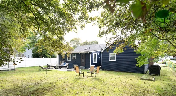 a view of a house with swimming pool and sitting area