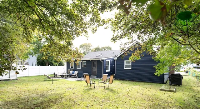 a view of a house with swimming pool and sitting area