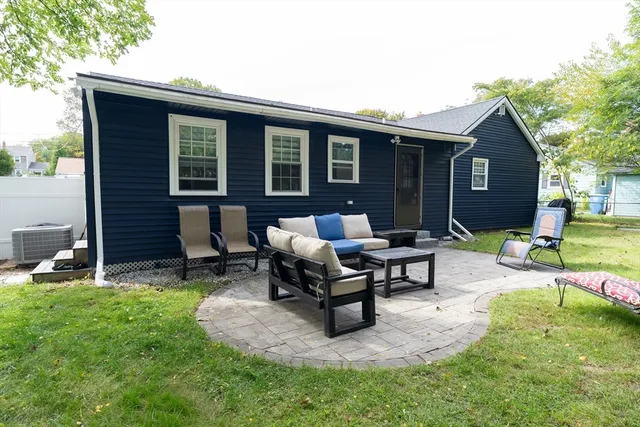 a view of a house with backyard porch and sitting area