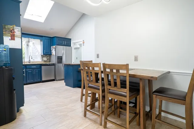 a kitchen with stainless steel appliances a refrigerator and wooden cabinets
