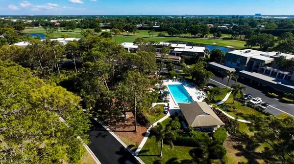 an aerial view of residential houses with outdoor space and river