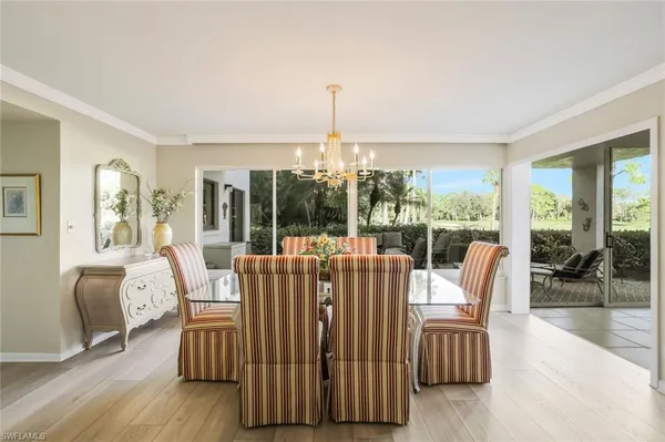 a living room with furniture and large windows