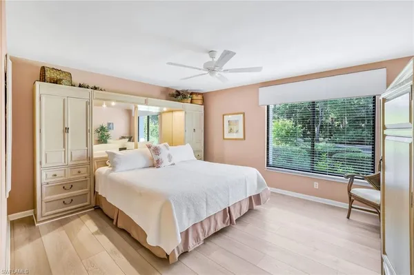 a bedroom with a large bed and a large window