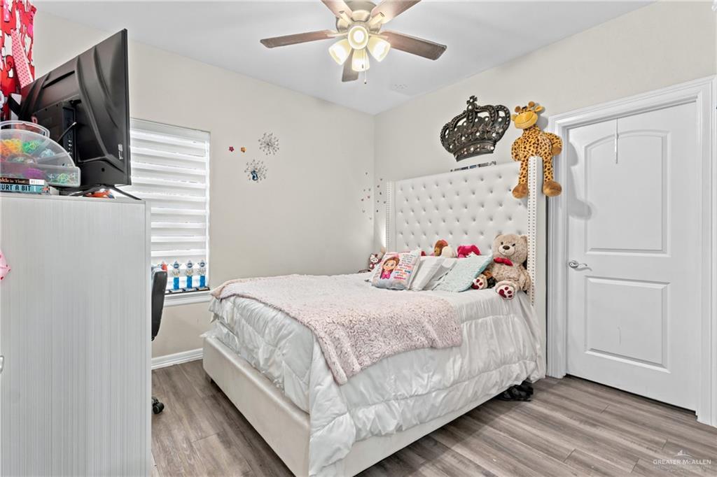 1904 Ridgeway Circle Edinburg, TX 78542 - Photo 16 of 32 Interior room featuring wood-finish flooring and light-toned walls