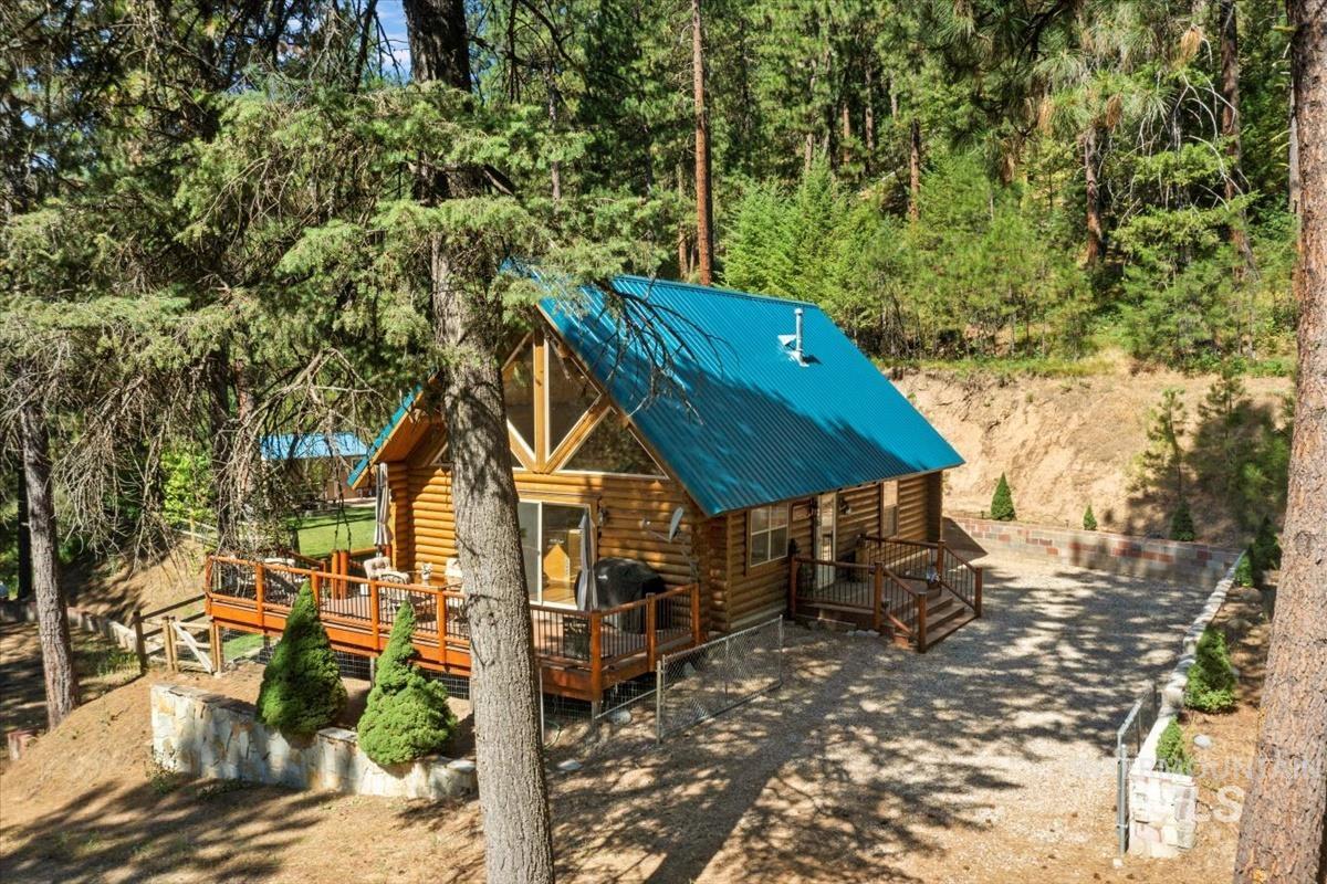 10 Elk Point Road Garden Valley, ID 83622 - Photo 6 of 42 View of front facade featuring log siding, a deck, and a metal roof