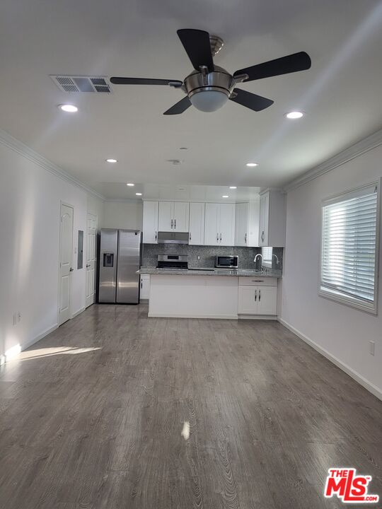 a view of a kitchen with a sink and cabinets
