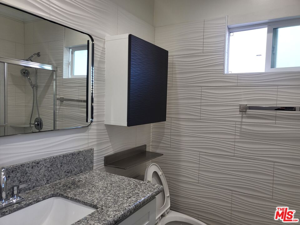 2754 West 12th Street Los Angeles, CA 90006 - Photo 8 of 17 a bathroom with a sink and a mirror