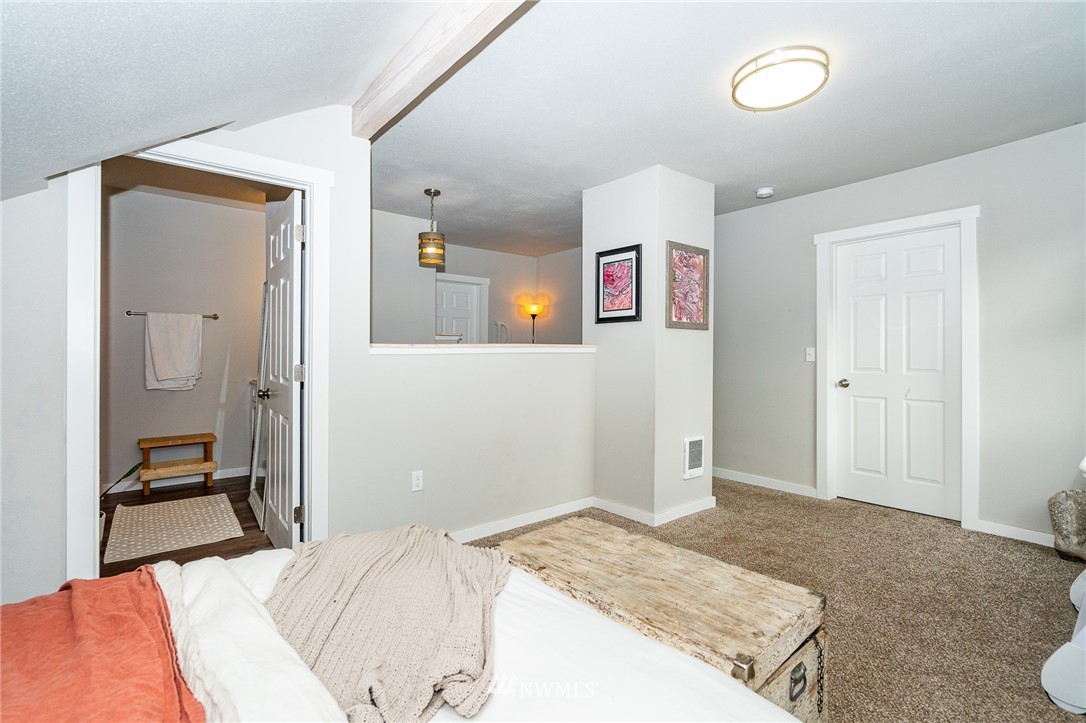 443 Tucker Road Toledo, WA 98591 - Photo 29 of 39 a bedroom with a bed and a dresser in it