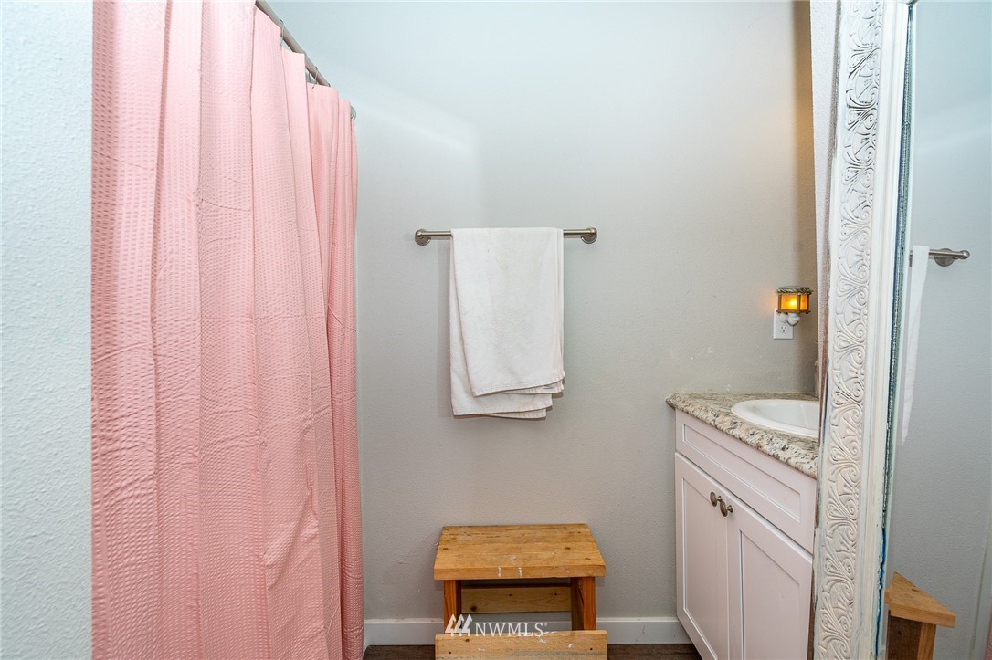 443 Tucker Road Toledo, WA 98591 - Photo 30 of 39 a bathroom with a granite countertop sink and a mirror