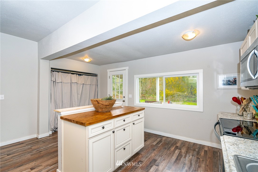 443 Tucker Road Toledo, WA 98591 - Photo 7 of 39 a view of a kitchen with wooden floor and sink