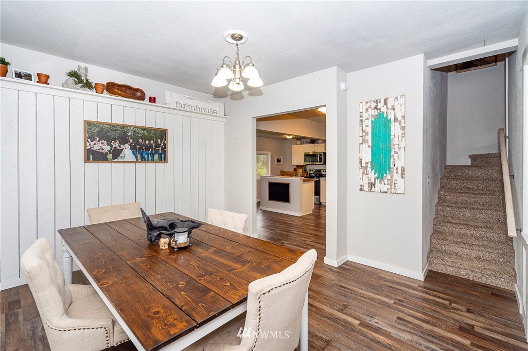 443 Tucker Road Toledo, WA 98591 - Photo 8 of 39 a view of a dining room with furniture wooden floor and chandelier