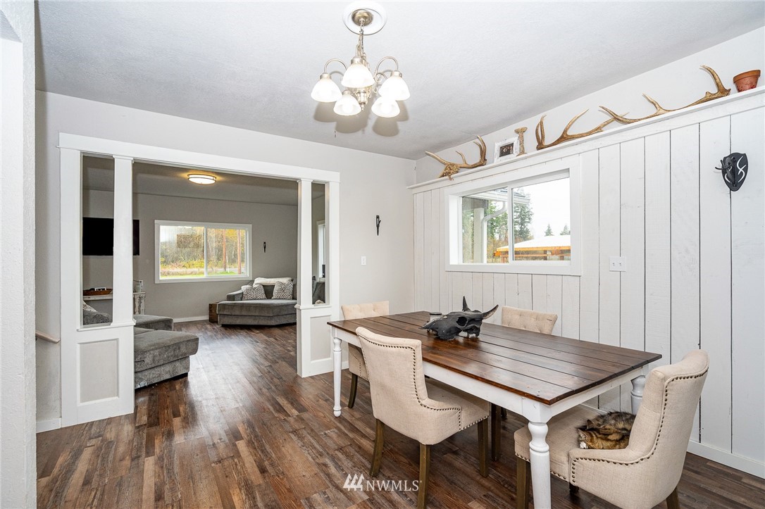 443 Tucker Road Toledo, WA 98591 - Photo 9 of 39 a view of a dining room with furniture and wooden floor
