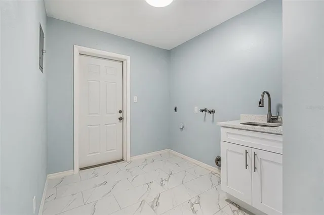 a bedroom with a sink and a mirror