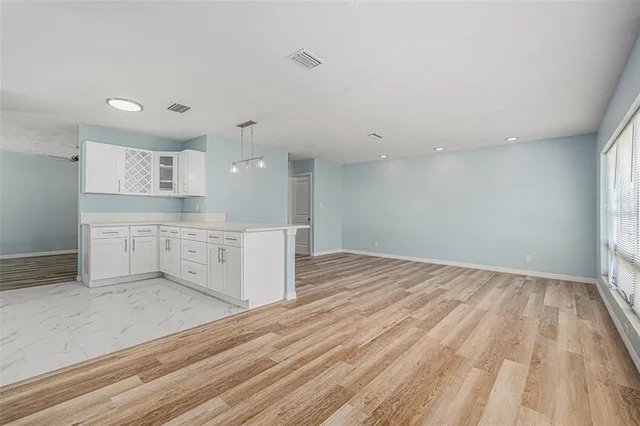 a view of kitchen with wooden floor and window