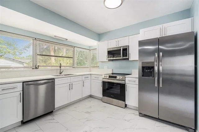 a kitchen with a refrigerator sink and microwave
