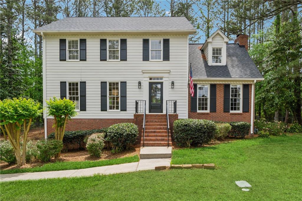 1275 Mayfield Road Alpharetta, GA 30009 - Photo 1 of 1 a front view of a house with a yard