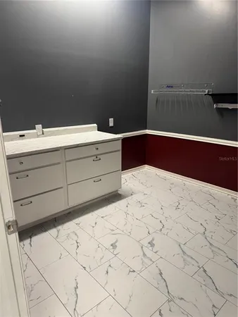 a bathroom with a sink vanity and mirror