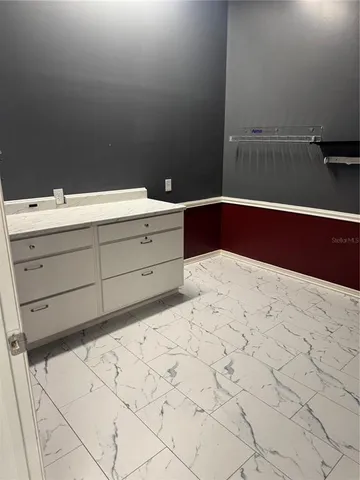 a bathroom with a sink vanity and mirror