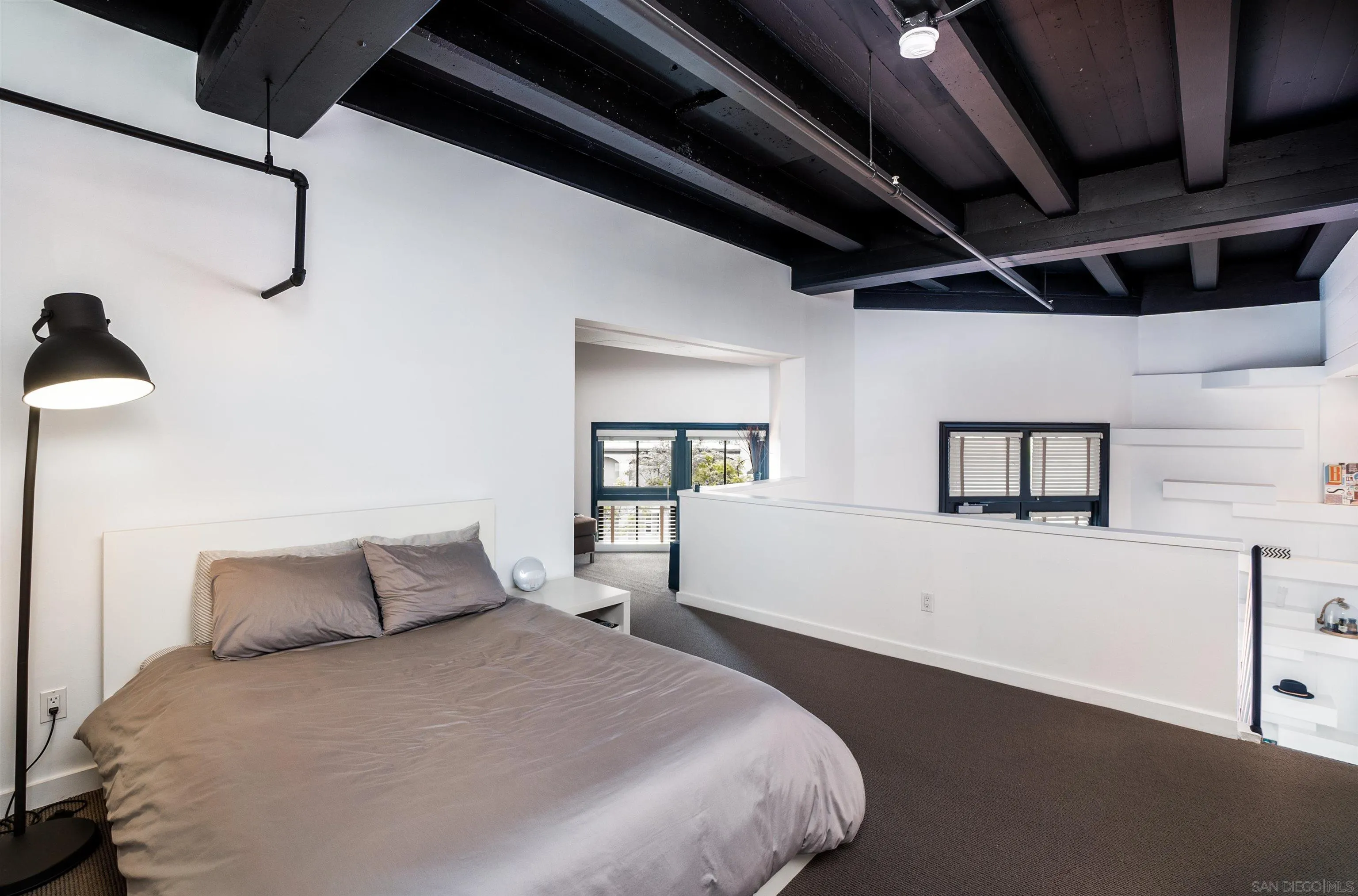 702 Ash Street, Unit 102 San Diego, CA 92101 - Photo 16 of 31 a bedroom with a bed and a night stand