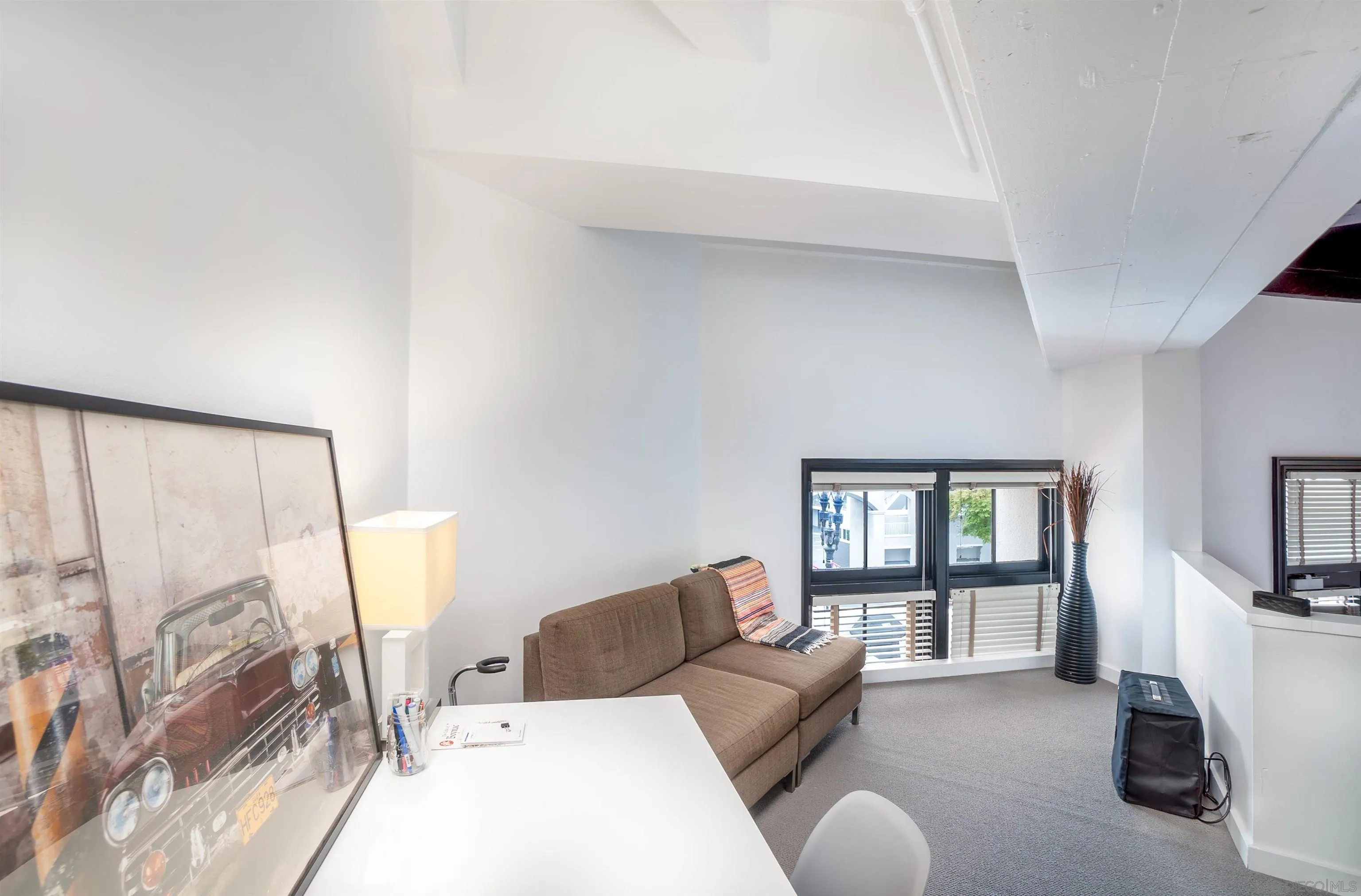 702 Ash Street, Unit 102 San Diego, CA 92101 - Photo 18 of 31 a living room with furniture and a flat screen tv