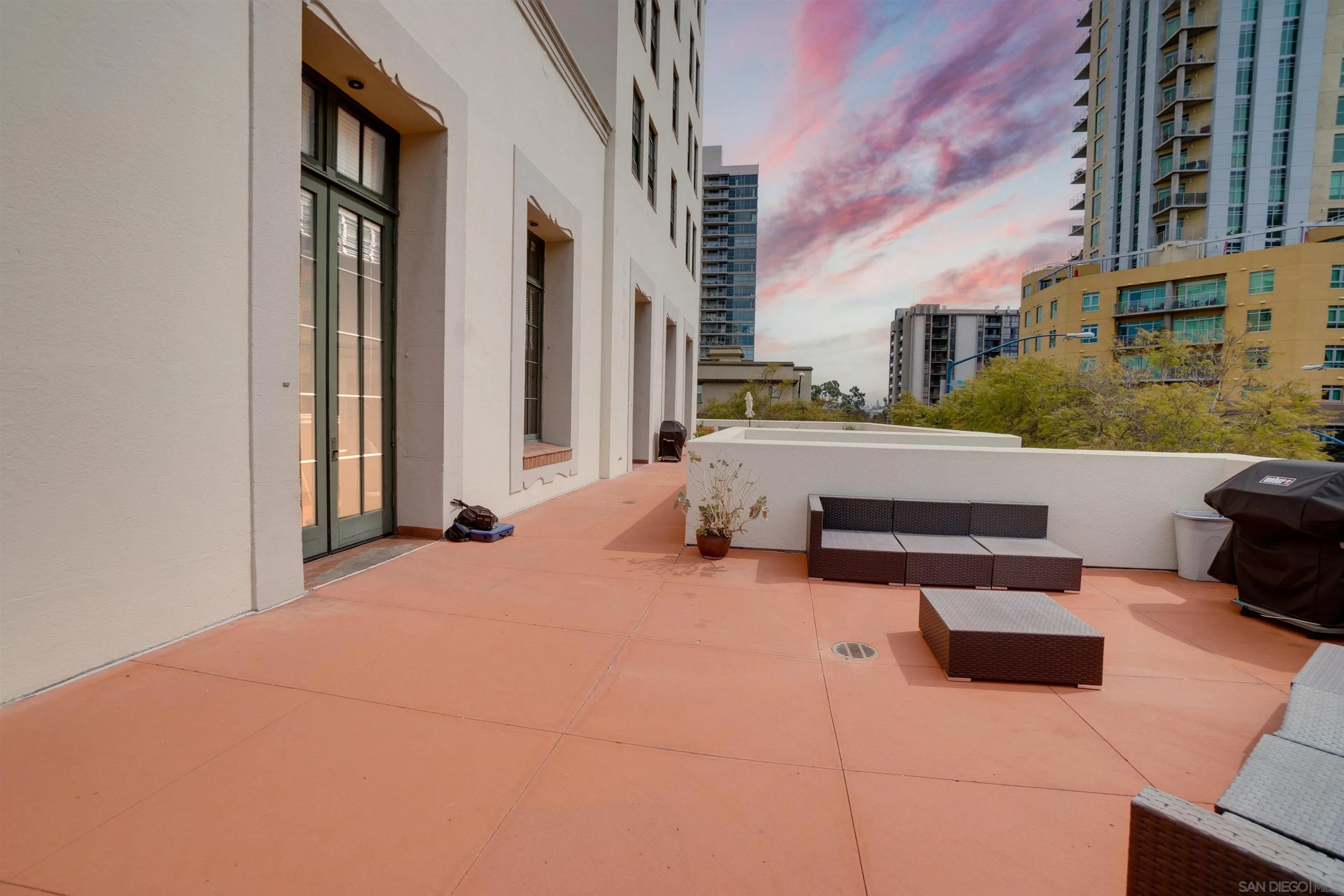 702 Ash Street, Unit 102 San Diego, CA 92101 - Photo 26 of 31 a roof deck with couches and wooden floor