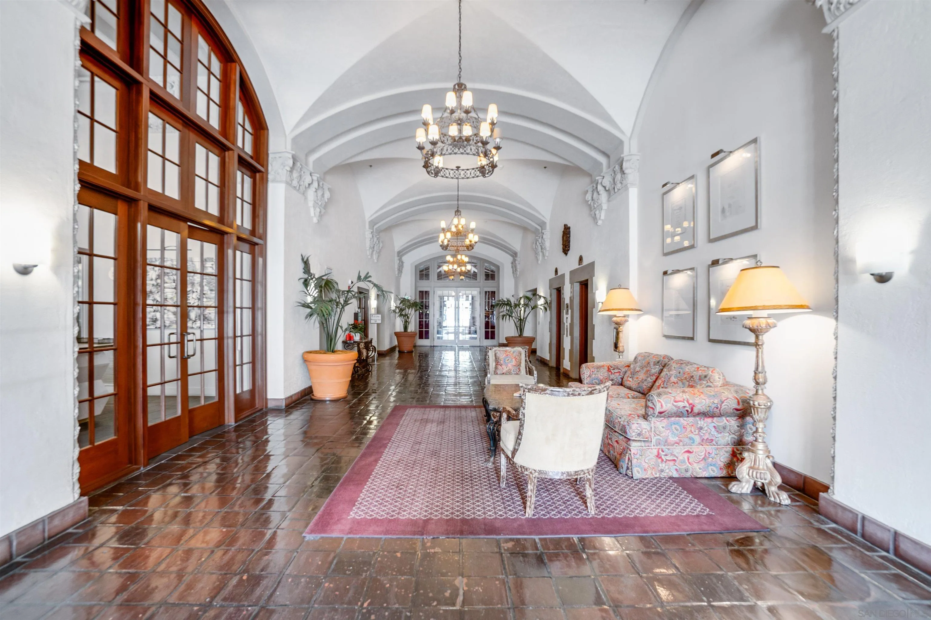 702 Ash Street, Unit 102 San Diego, CA 92101 - Photo 29 of 31 a living room with fireplace furniture and a chandelier