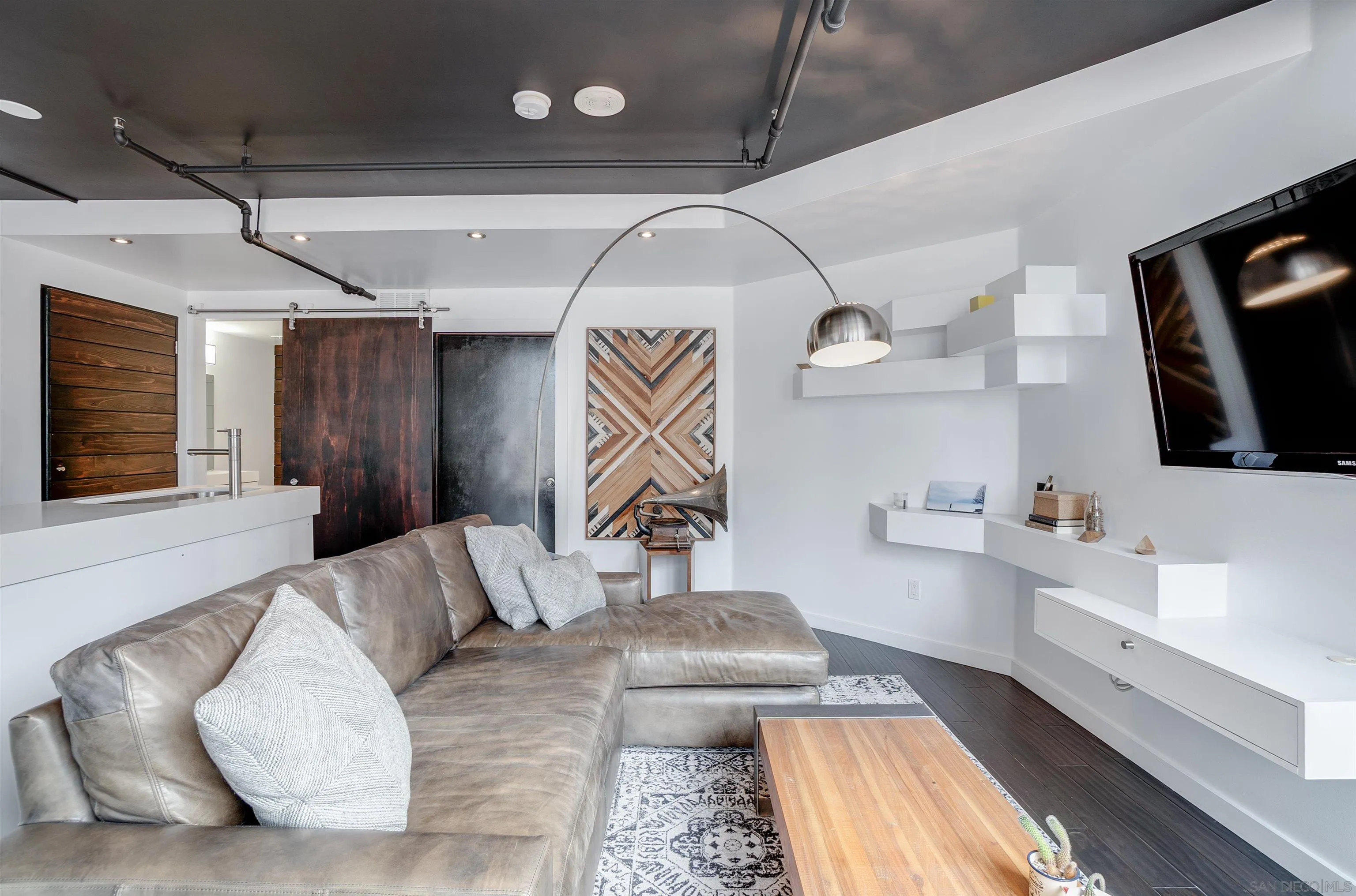 702 Ash Street, Unit 102 San Diego, CA 92101 - Photo 5 of 31 a living room with furniture and flat screen tv