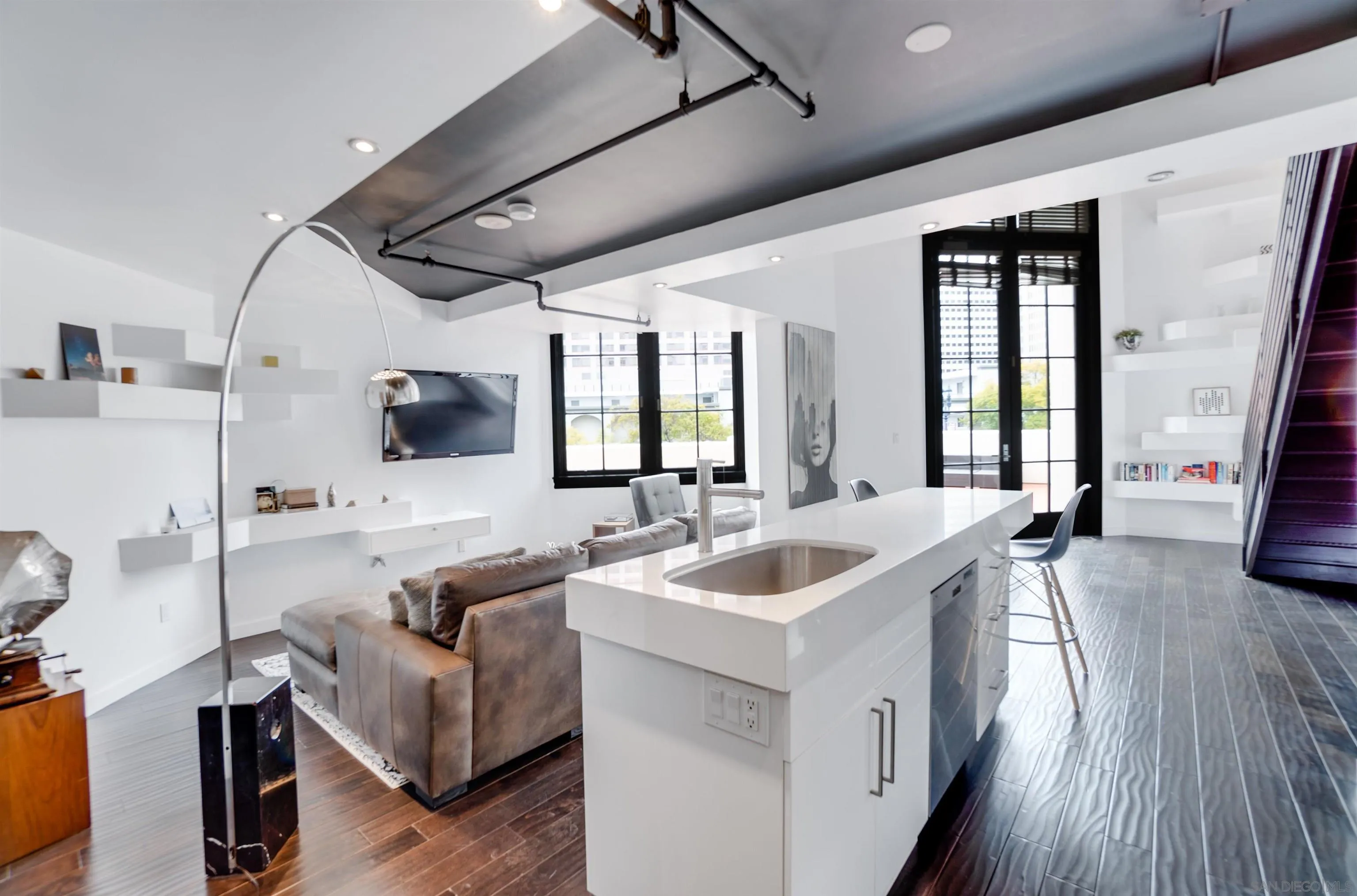 702 Ash Street, Unit 102 San Diego, CA 92101 - Photo 8 of 31 a living room with furniture and flat screen tv