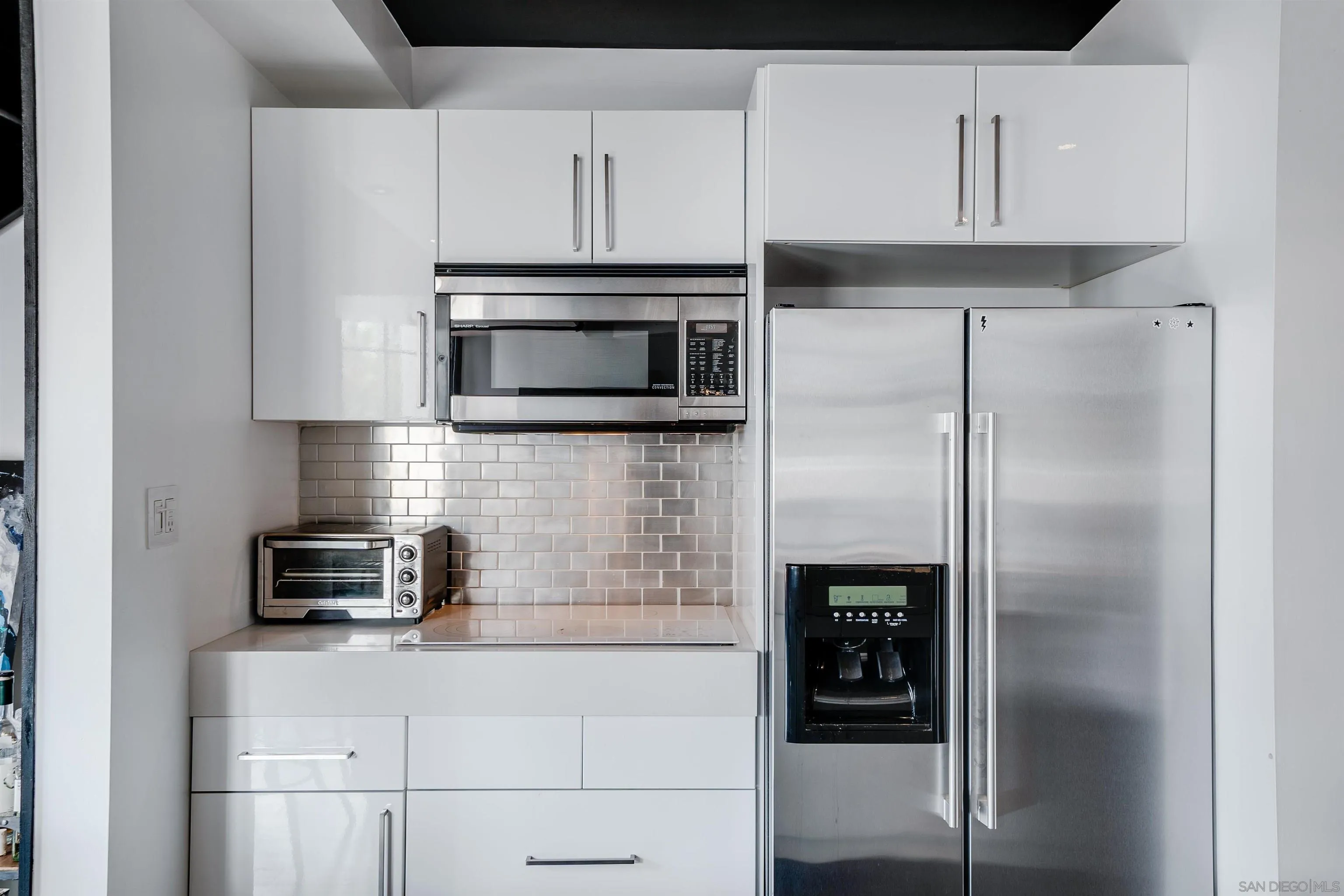 702 Ash Street, Unit 102 San Diego, CA 92101 - Photo 10 of 31 a kitchen with cabinets and stainless steel appliances