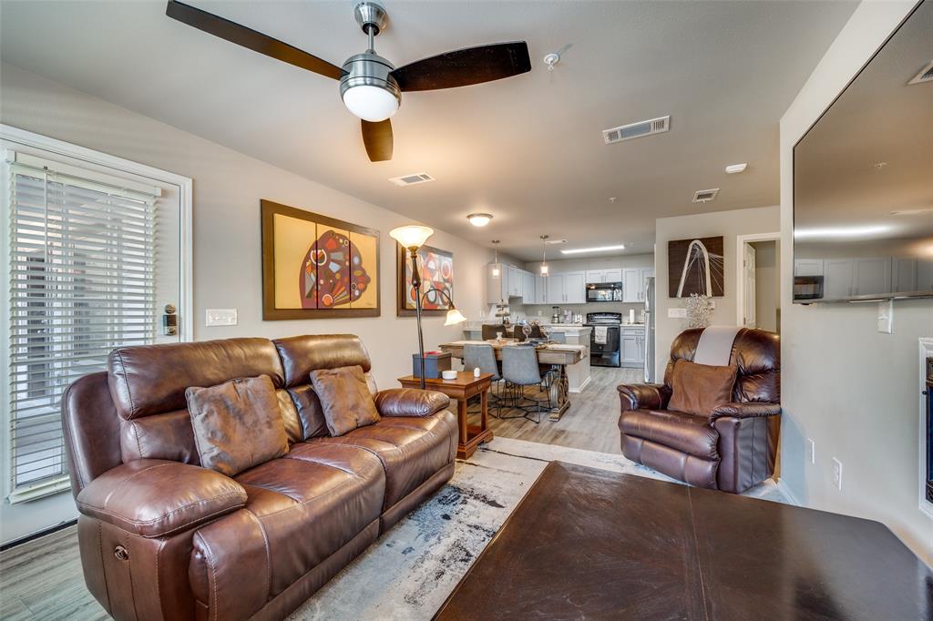 6108 Abrams Road, Unit 205 Dallas, TX 75231 - Photo 4 of 12 Living room featuring light wood finished floors and ceiling fan