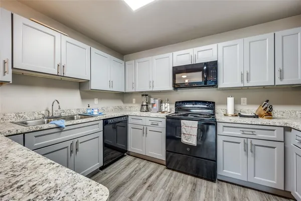 a kitchen with stainless steel appliances granite countertop a stove sink and cabinets