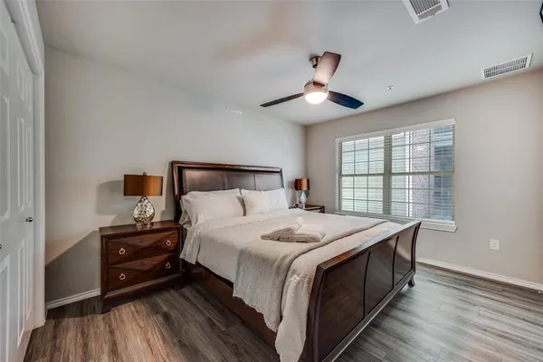 a bedroom with a bed and a large window