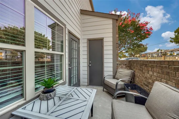 a view of a patio with couches table and chairs and potted plants